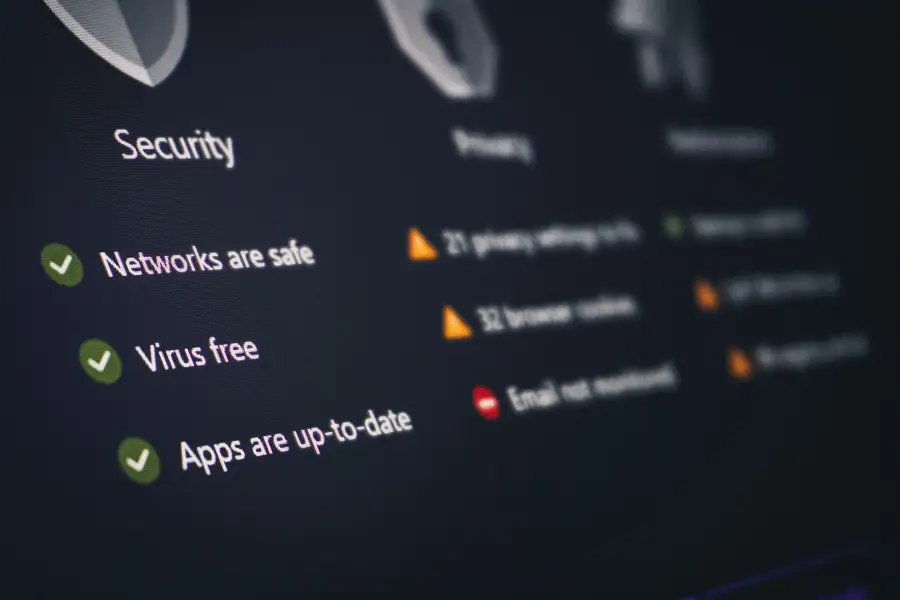 Tech-business security dashboard showing networks safe; virus free; and apps up-to-date with green checkmarks on dark UI.